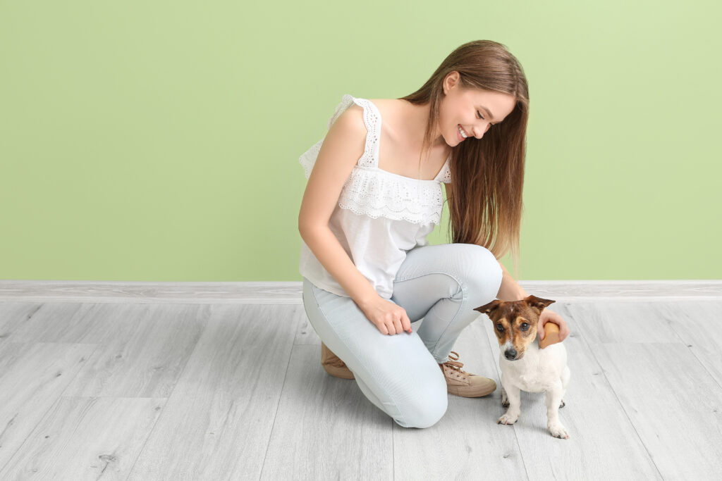 Young woman with cute dog indoors